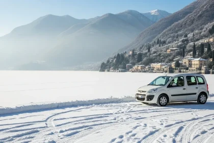 Van blanc près du lac gelé de Côme en hiver